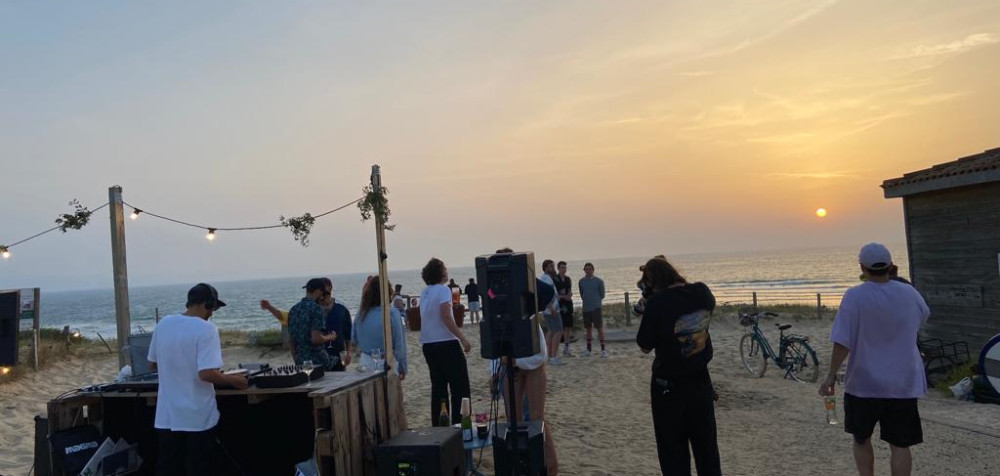 Party am Strand bei Sonnenuntergang<br />
DJ<br />
Musikboxen<br />
junge Menschen